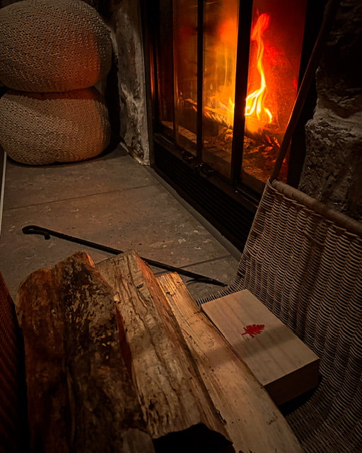 Decorative box set beside a mantle for convenience and style
